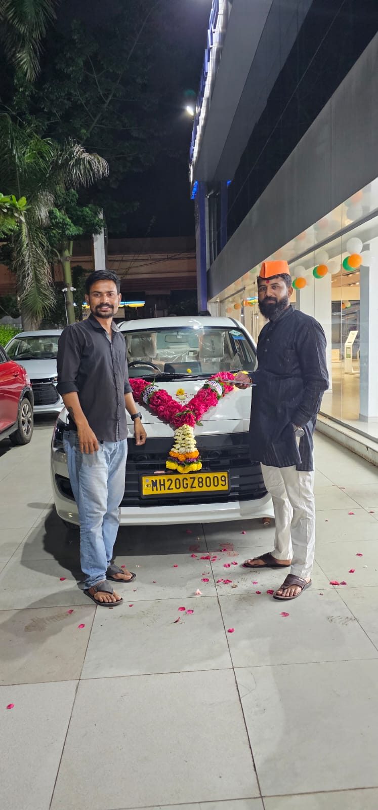 New car delivery alongside a Pragati Travels coach - Aurangabad
